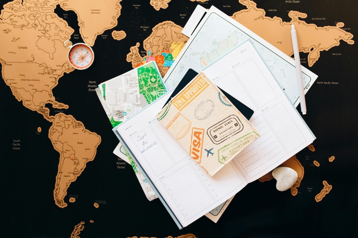 Travel planning flat lay with passport, compass and map