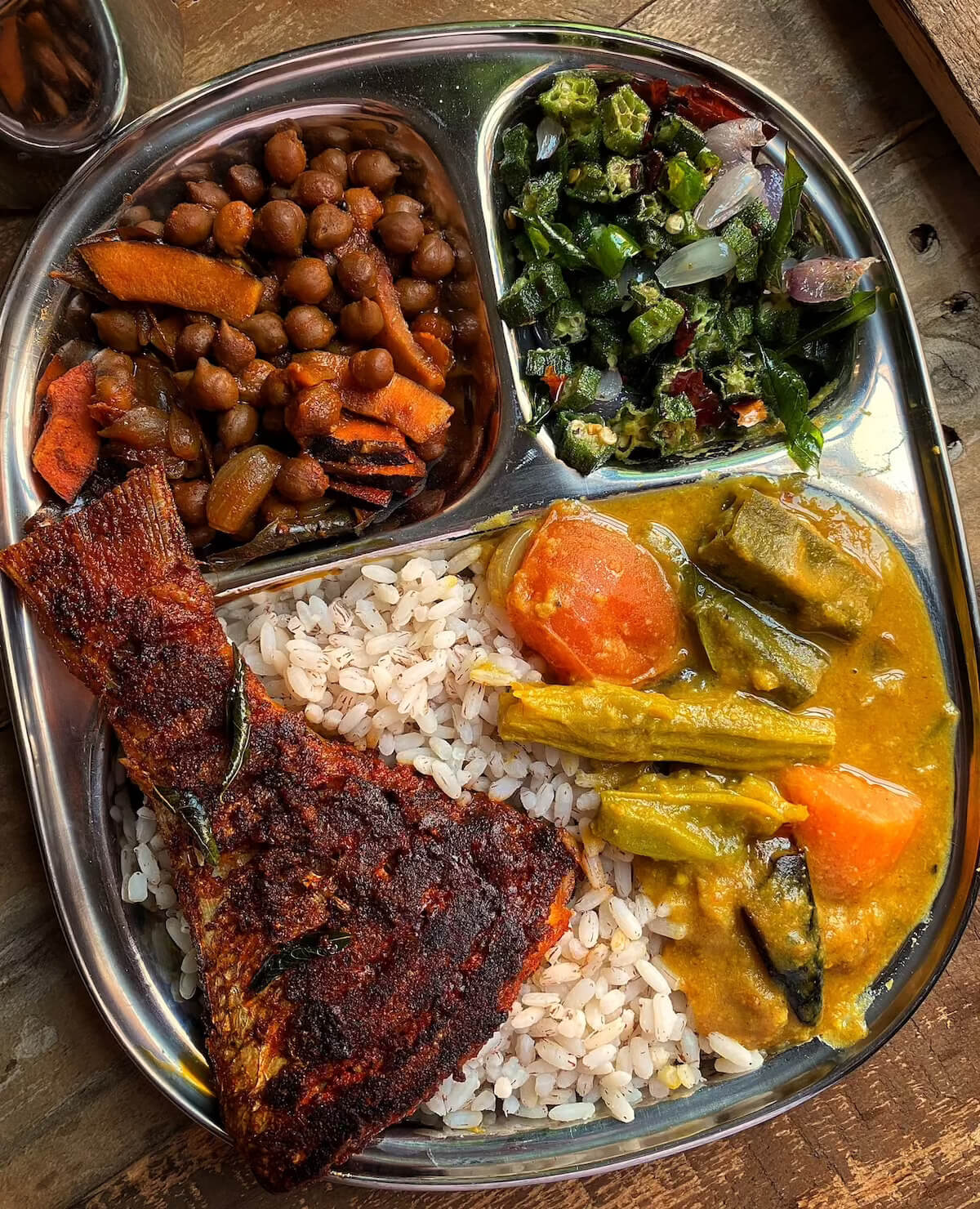 A simple vegetarian meal of dal, rice and vegetables served on a steel thali