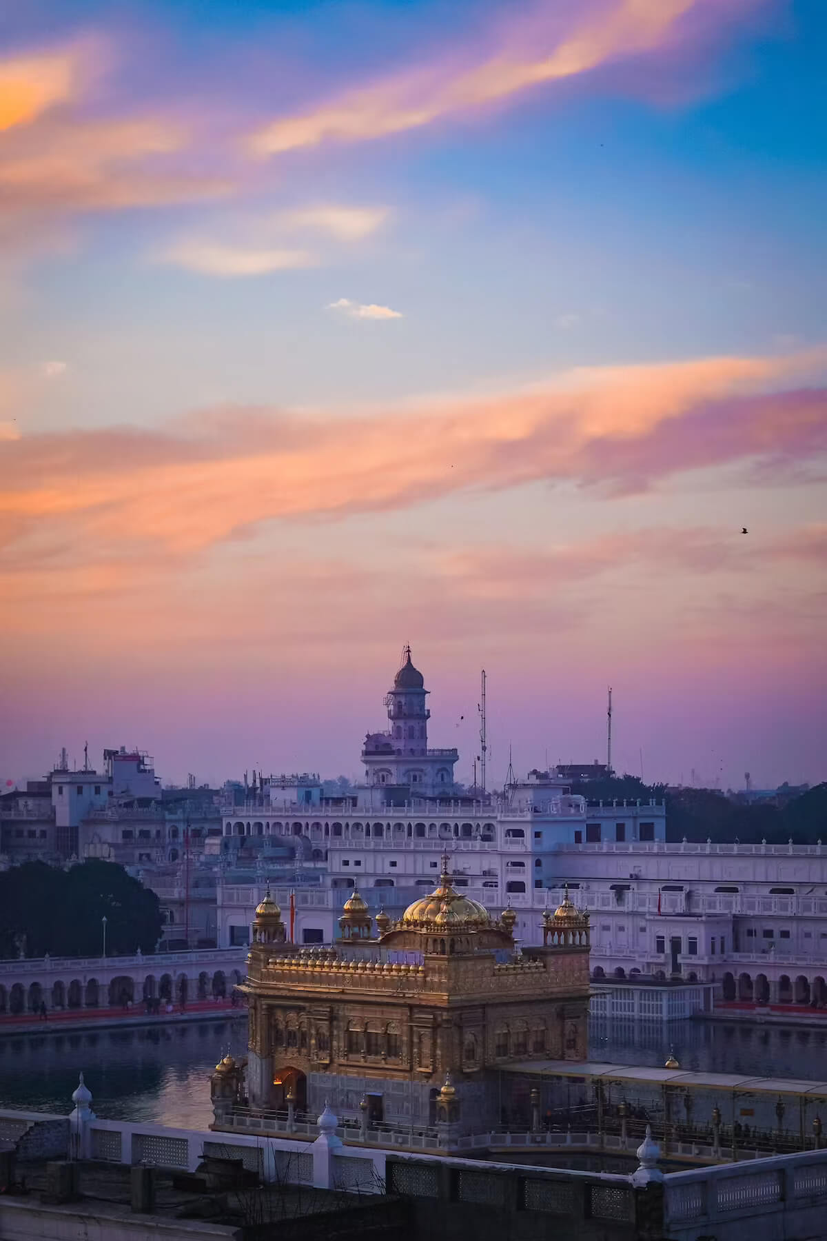 Aerial view of the Golden Temple complex and its surrounding sacred pool at sunset in Amritsar, Punjab