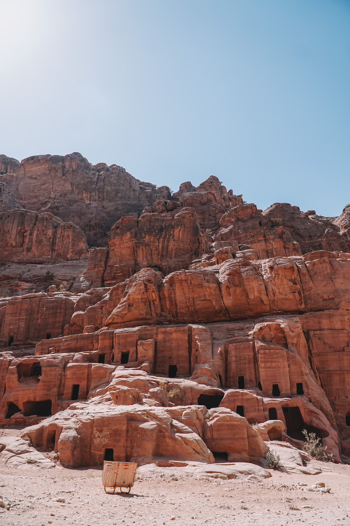 Rows of carved sandstone tomb facades along the Street of Facades in Petra, Jordan