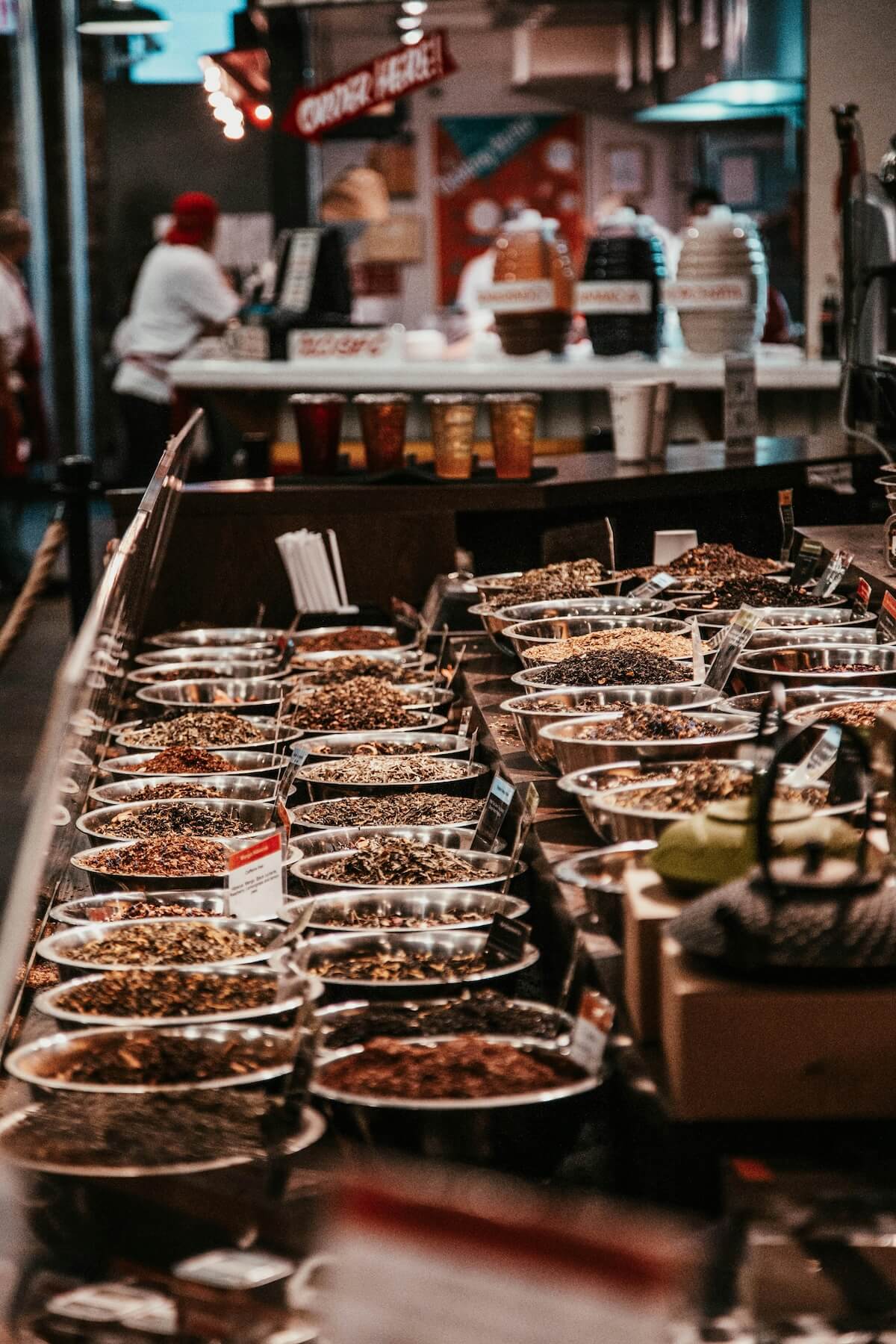Colorful variety of spices displayed in bowls at a traditional market