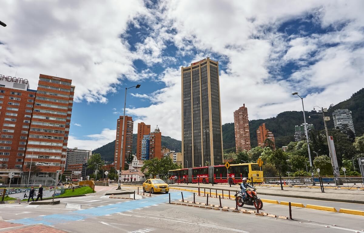 Vibrant street scene in downtown Bogotá with TransMilenio bus