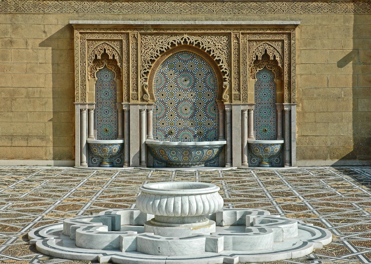Ornate Moroccan fountain with geometric tile patterns in a courtyard