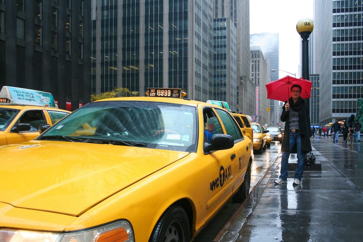 Yellow taxi cab on rainy city street