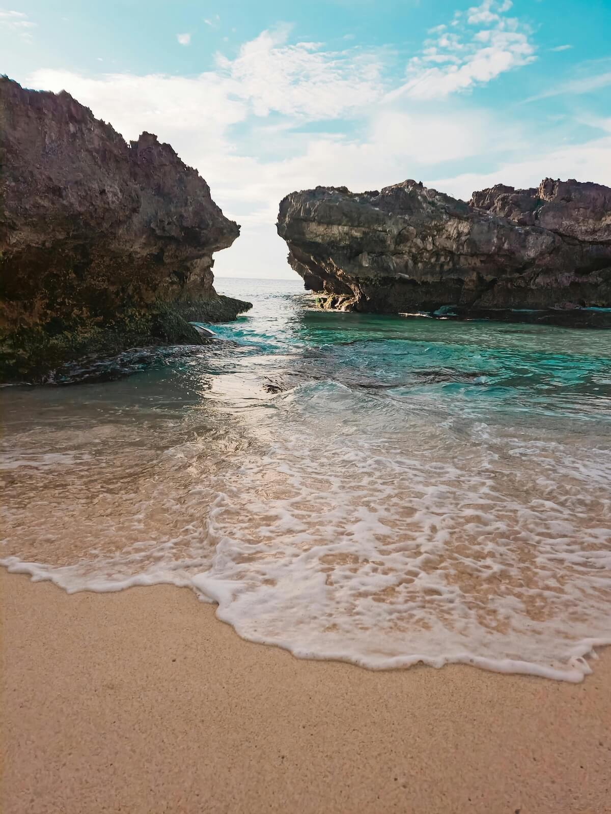 Scenic beach cove with crystal clear turquoise waters and rocky cliffs