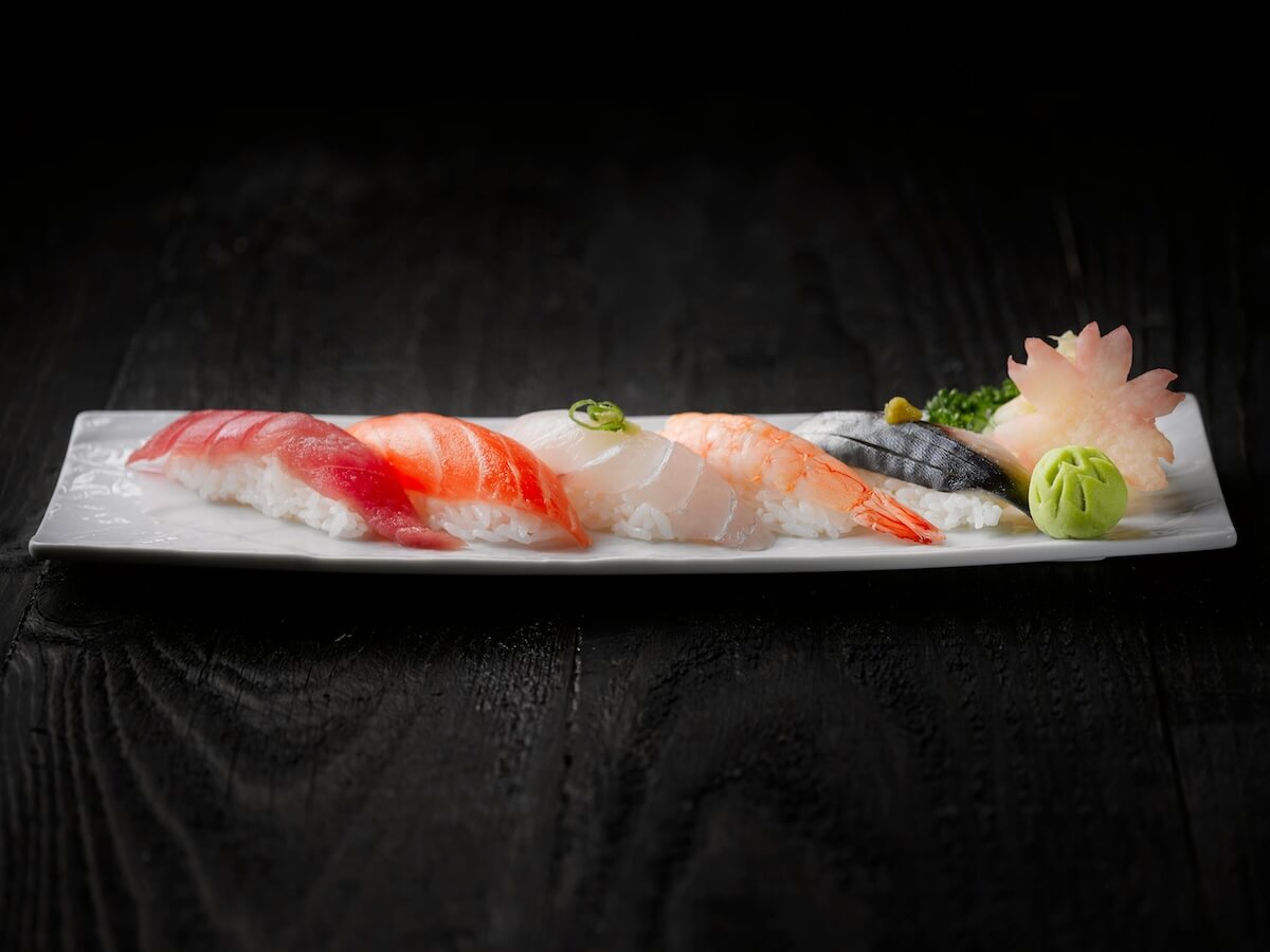 Beautifully arranged sushi platter featuring fresh sashimi on a sleek plate with wasabi