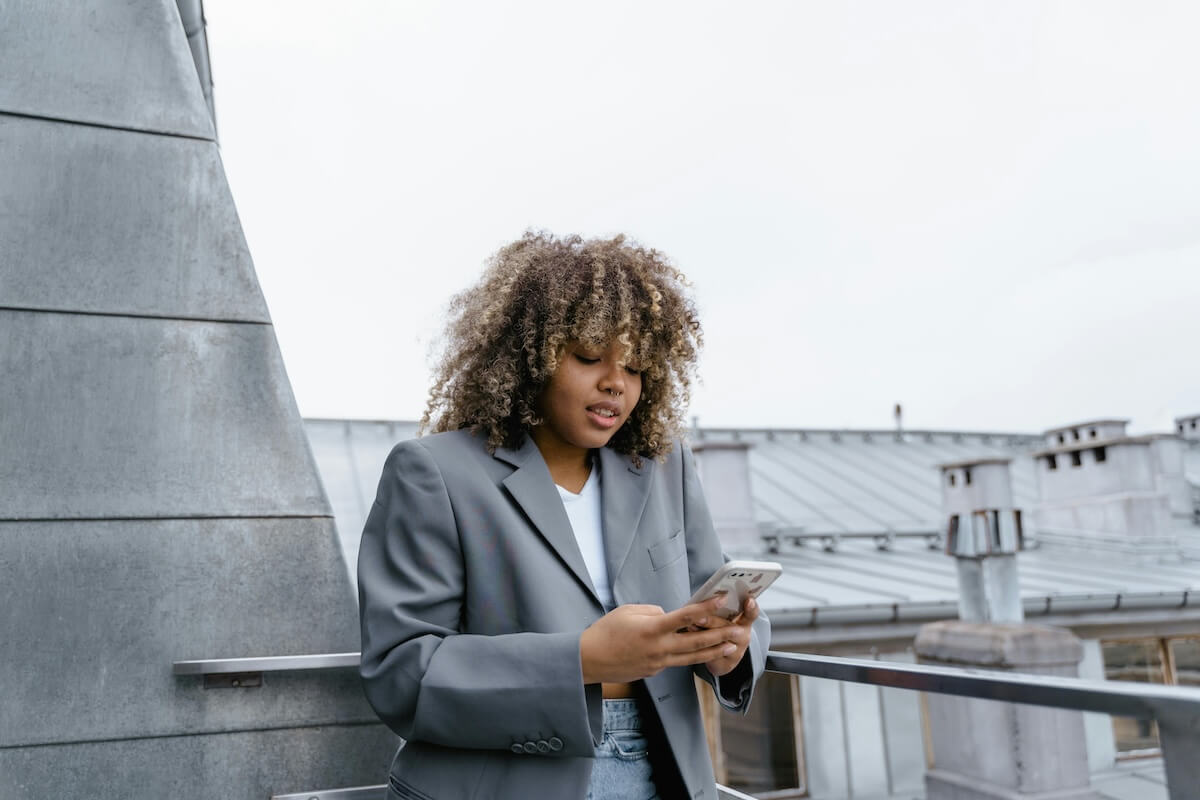 Woman using smartphone outdoors in urban setting