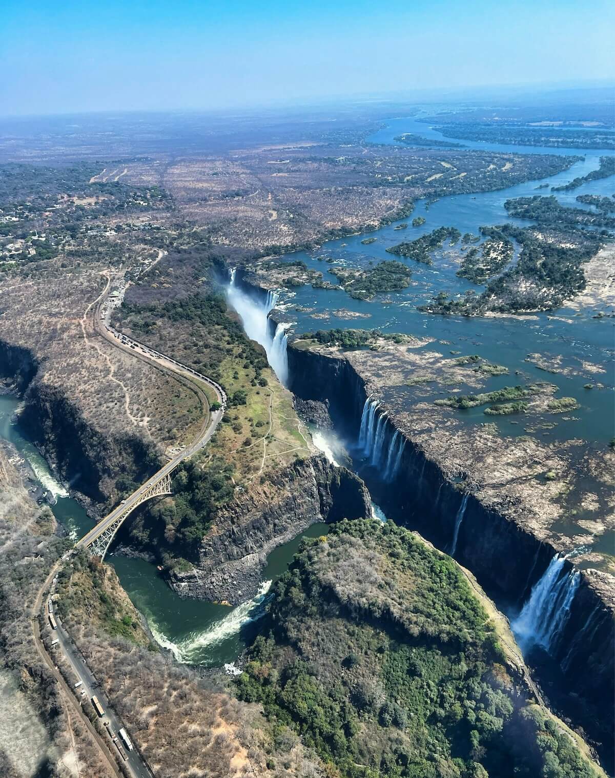 Dramatic aerial view of Victoria Falls surrounded by mist and gorge