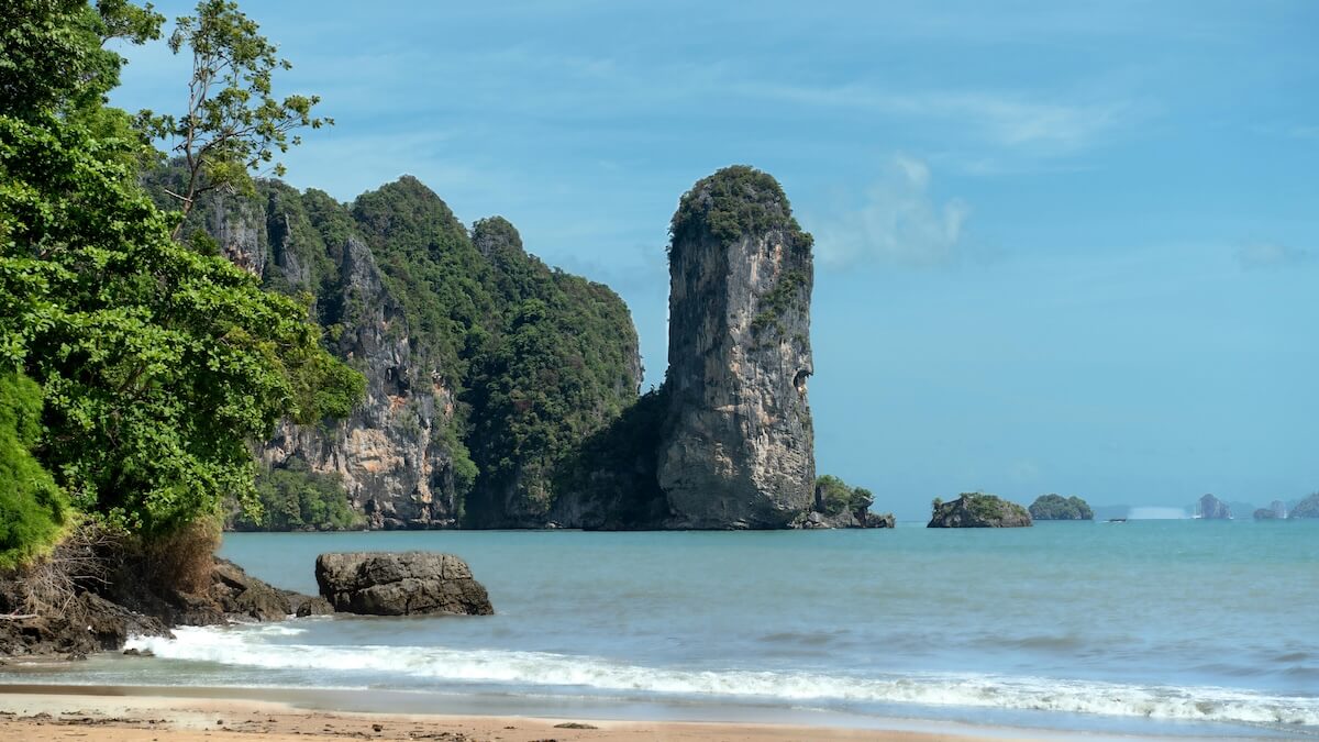 Majestic limestone cliffs rising from turquoise water at Ao Nang Beach in Krabi, Thailand