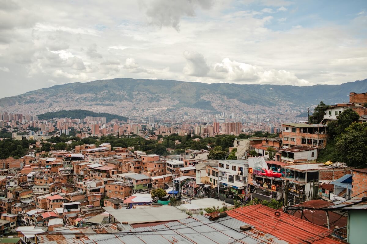 Colorful urban landscape of Medellín with rooftops and mountains
