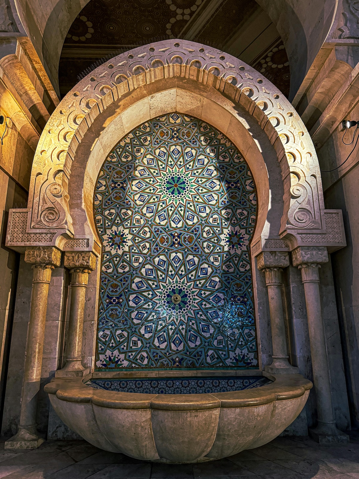 Intricate Moroccan tile mosaic with traditional geometric patterns in an archway