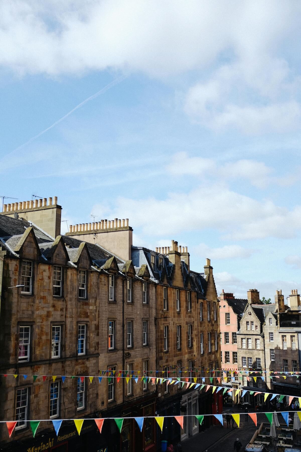 Royal Mile in Edinburgh with historic stone buildings and colorful bunting