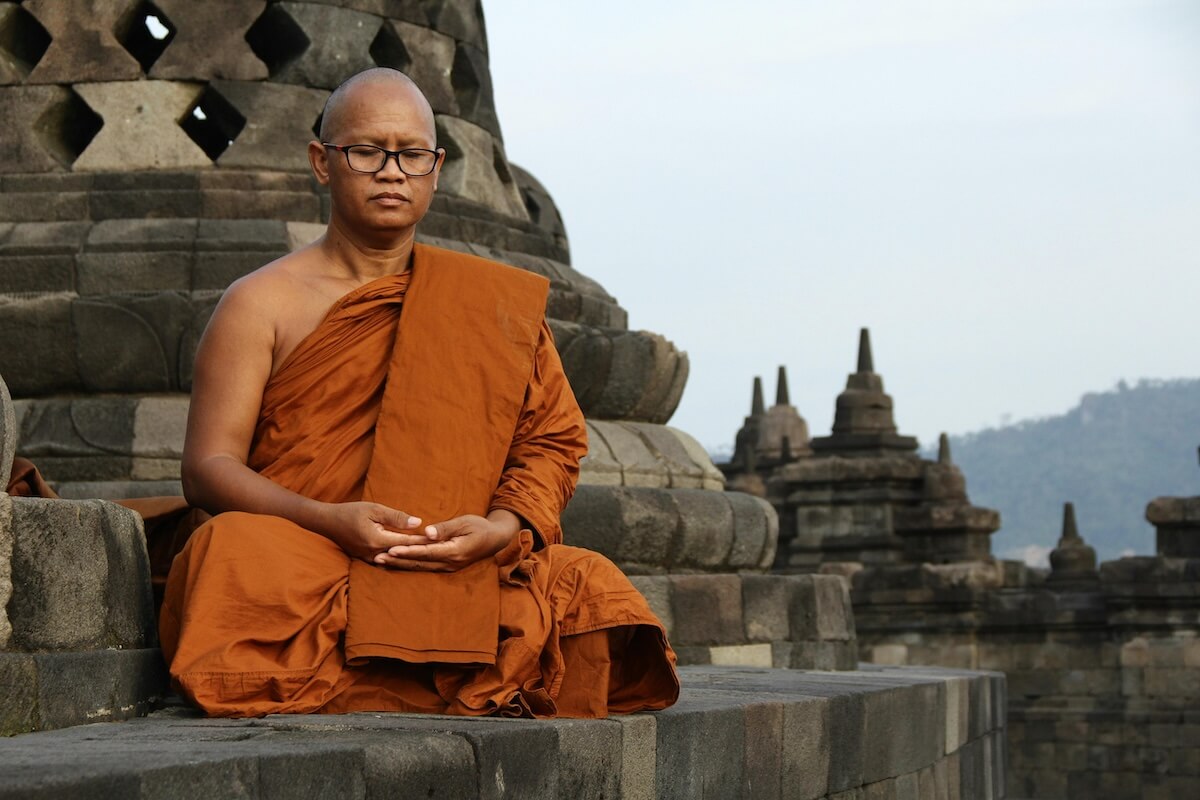 Buddhist monk sitting in meditation at a temple