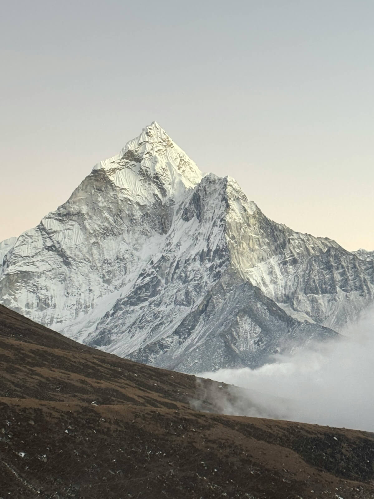 Mount Everest during sunrise with snow-capped peaks and misty valleys