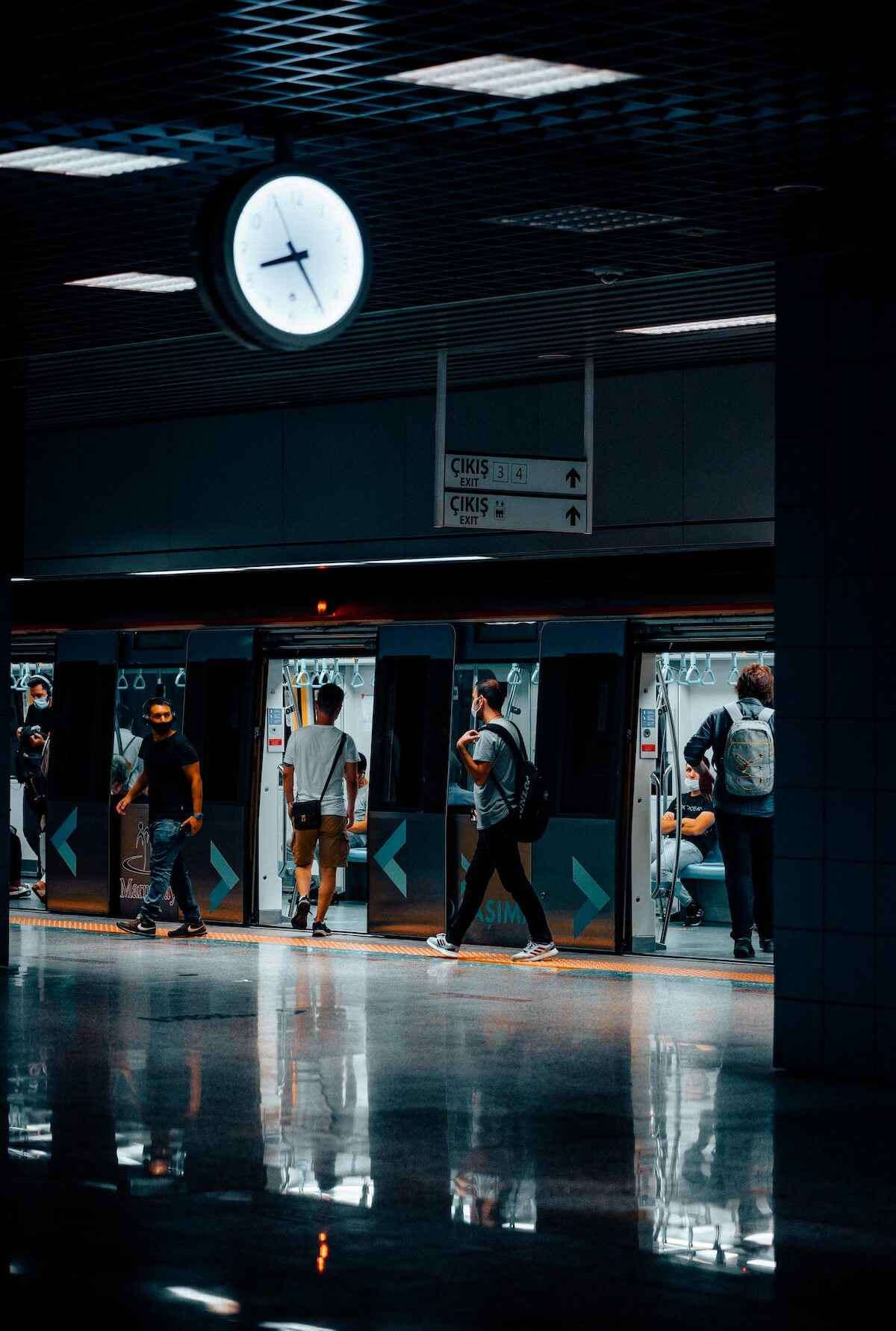 People entering and exiting metro subway car at station